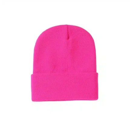 Bright pink knit beanie with folded cuff on white background.