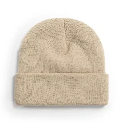 Beige knitted beanie with ribbed cuff on white background.