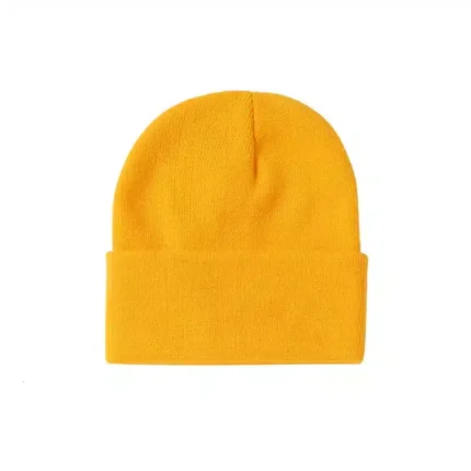 Bright yellow knitted beanie with folded cuff on white background.