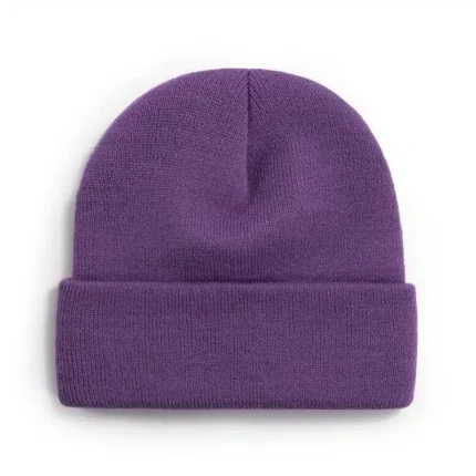 Vibrant purple knitted beanie with folded cuff on white background.