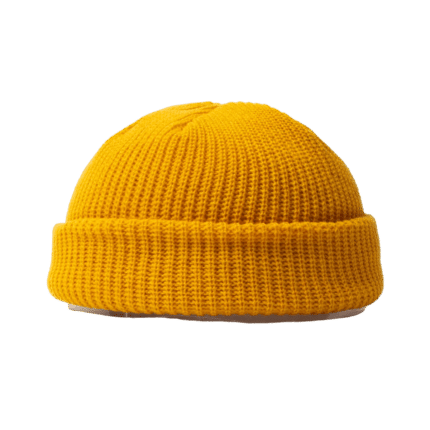 Yellow knitted beanie on monochromatic background.