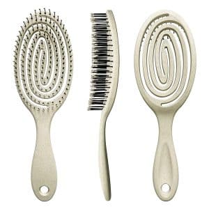 Three beige hairbrushes: vented detangler, slim teasing brush, and distinctive scalp massager.