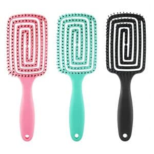 Set of colorful paddle hairbrushes - pink, turquoise, black with ergonomic handles.